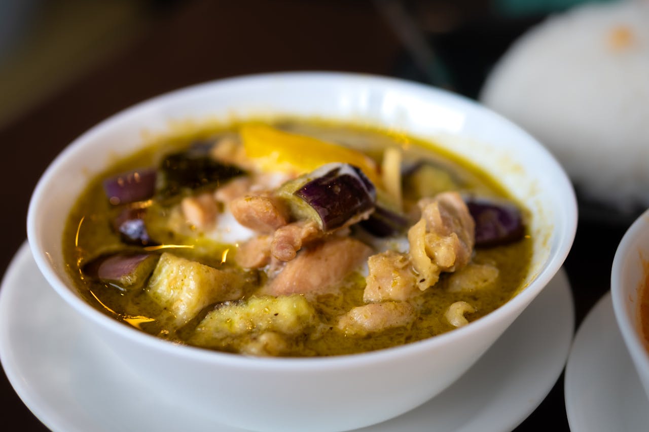 Savor the flavors of Asian curry with chicken and eggplant in a Tokyo restaurant bowl.